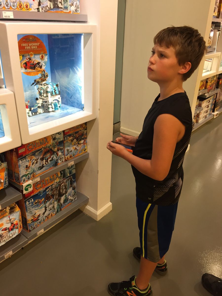 Jackson browsing LEGO sets at the LEGO Store as a boy